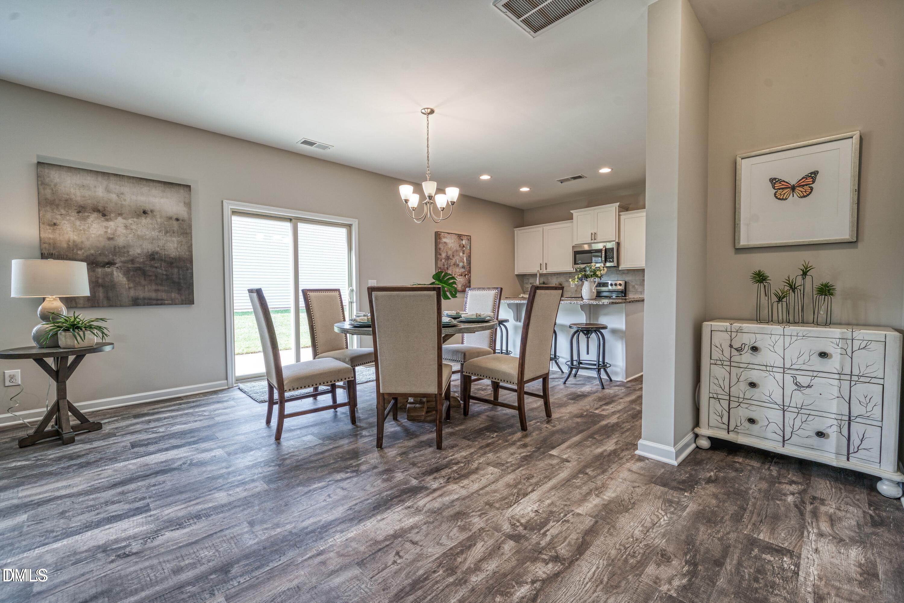 2304 Broad Street Durham, NC 27704 - Photo 12 of 39 a view of a dining room with furniture and wooden floor