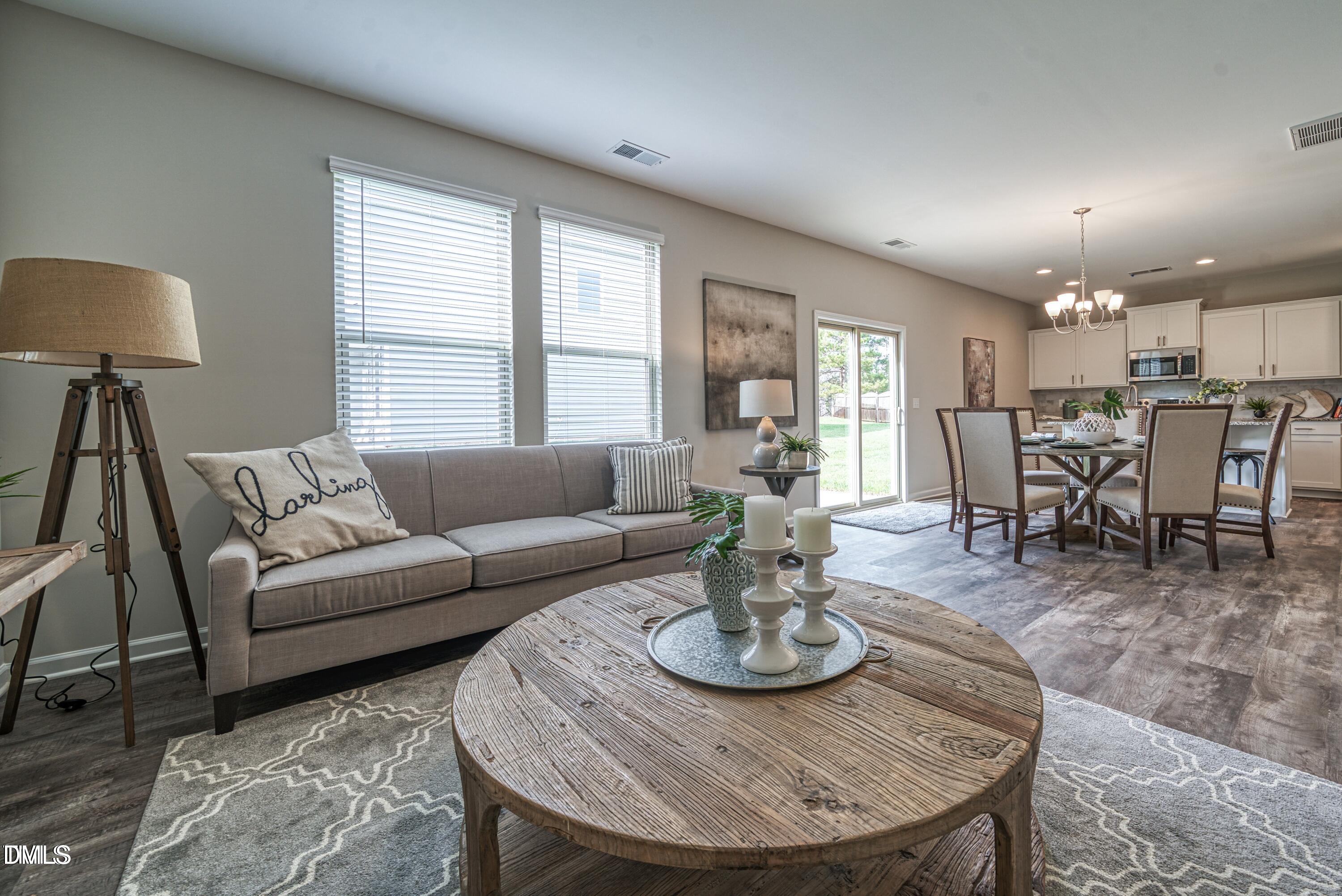 2304 Broad Street Durham, NC 27704 - Photo 15 of 39 a living room with furniture a dining table and a window