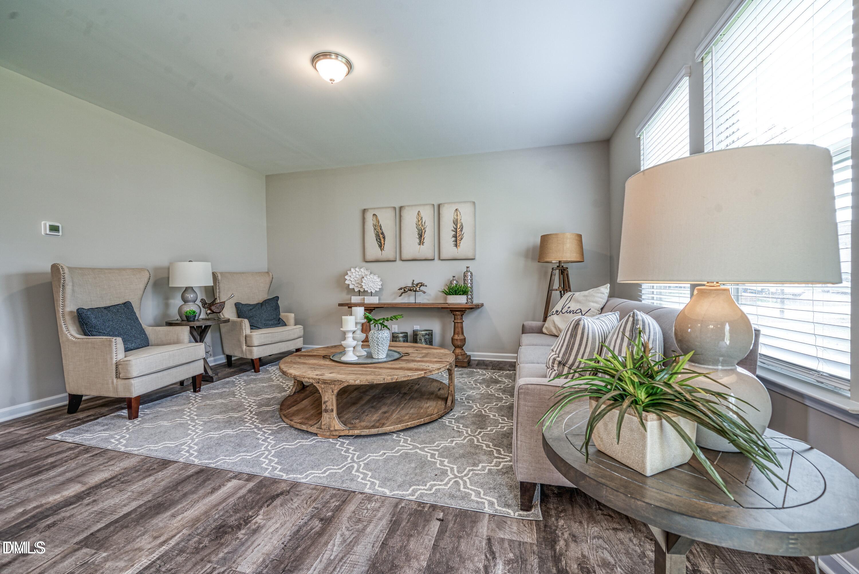 2304 Broad Street Durham, NC 27704 - Photo 17 of 39 a living room with furniture potted plant and a large window