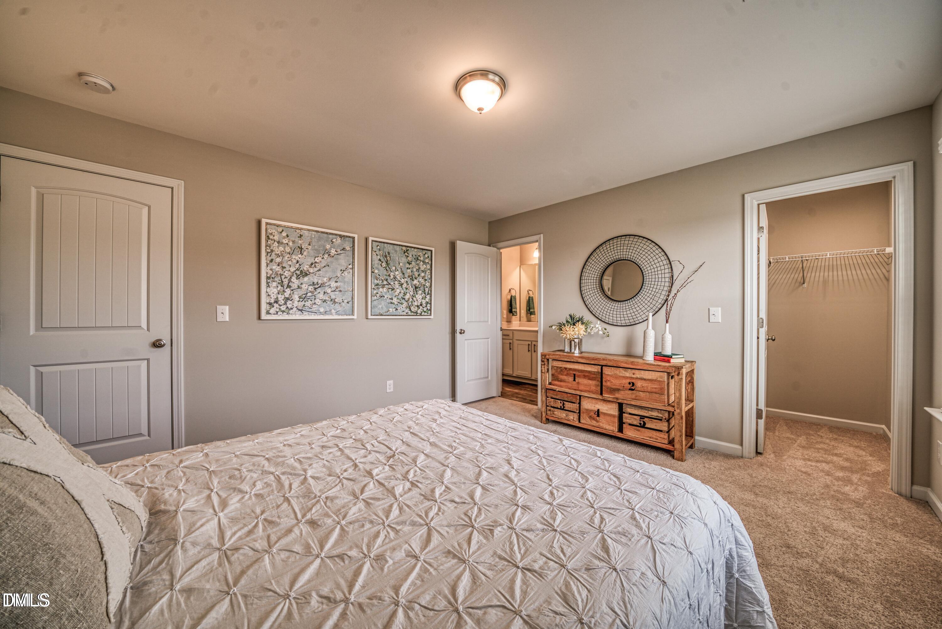 2304 Broad Street Durham, NC 27704 - Photo 29 of 39 a bedroom with a bed and a chandelier