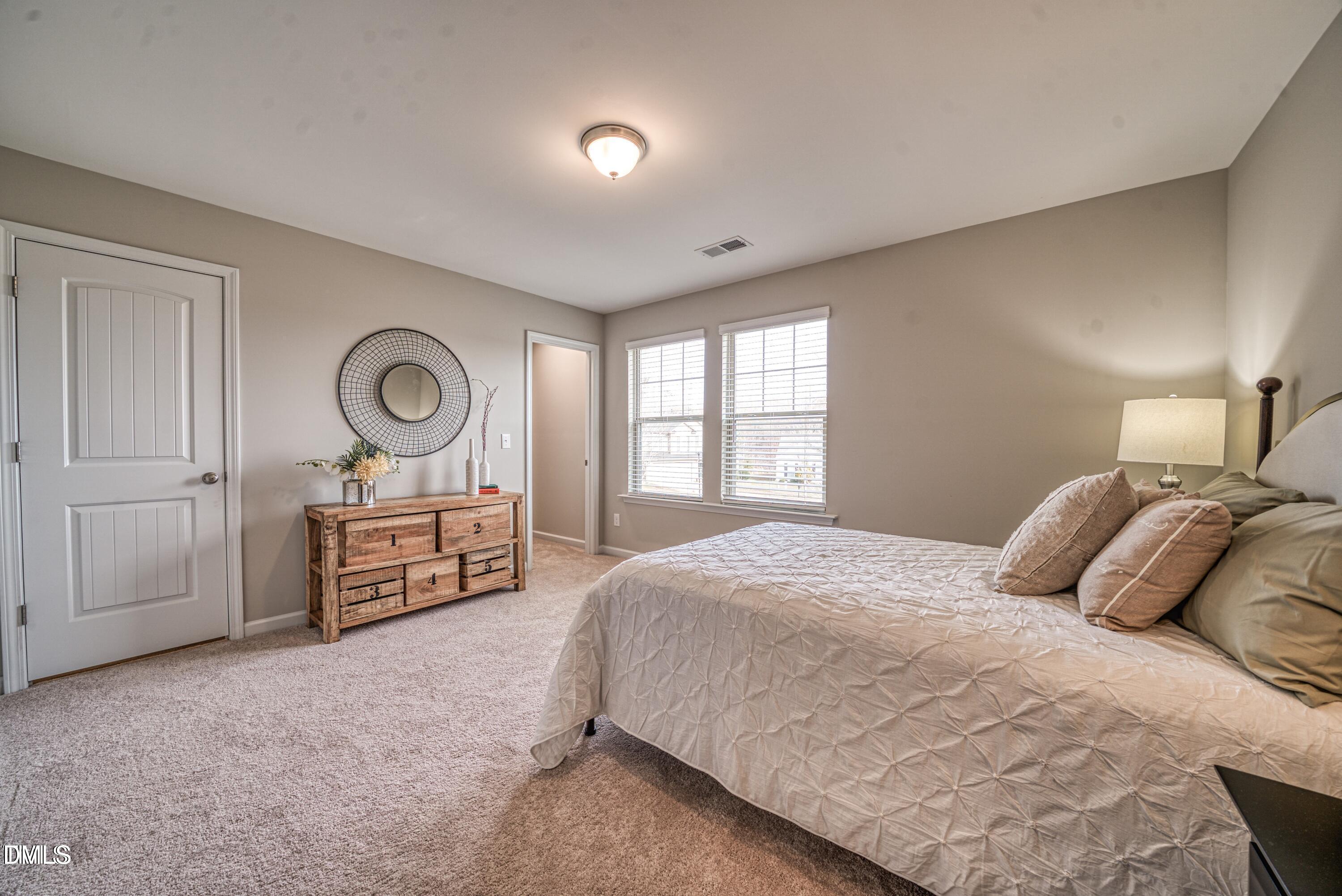 2304 Broad Street Durham, NC 27704 - Photo 30 of 39 a bedroom with a bed and dresser