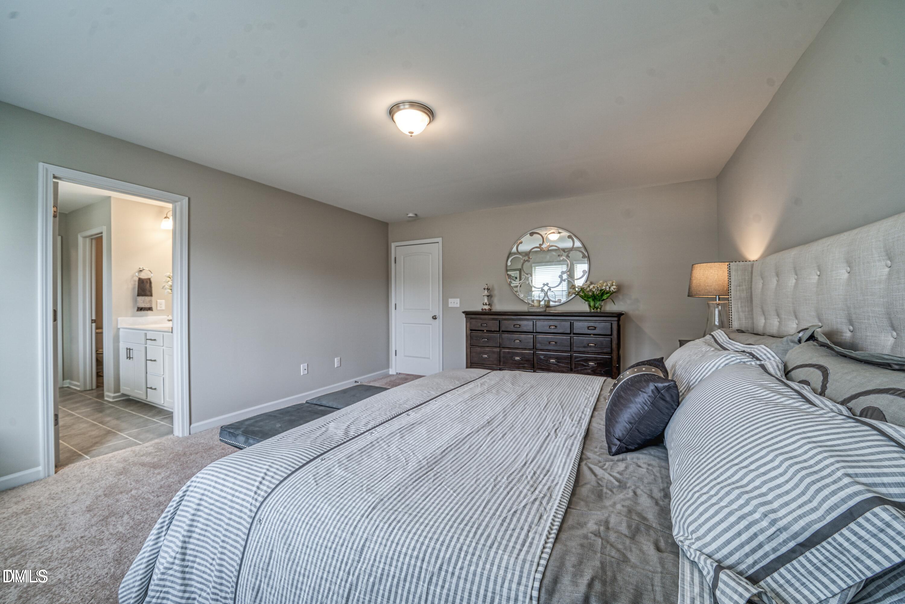 2304 Broad Street Durham, NC 27704 - Photo 34 of 39 a bedroom with a bed and a chandelier