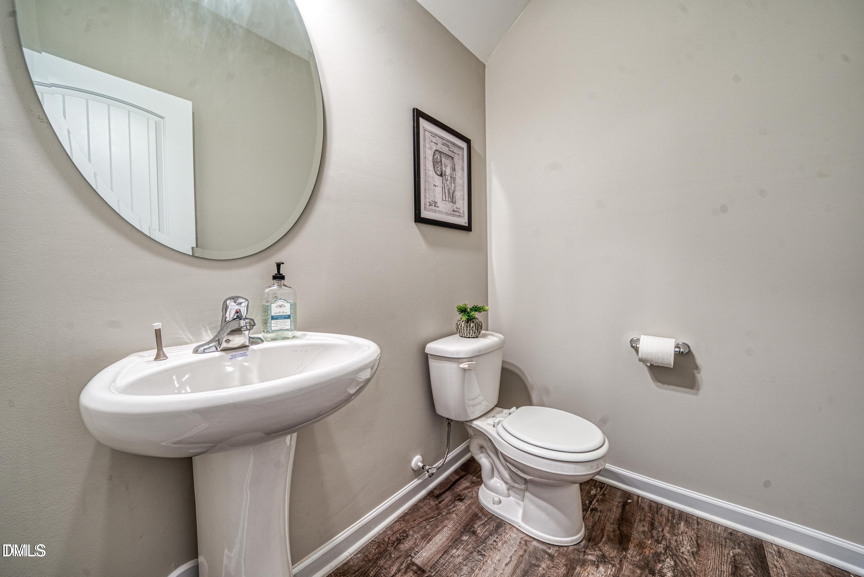 2304 Broad Street Durham, NC 27704 - Photo 39 of 39 a bathroom with a toilet sink and mirror