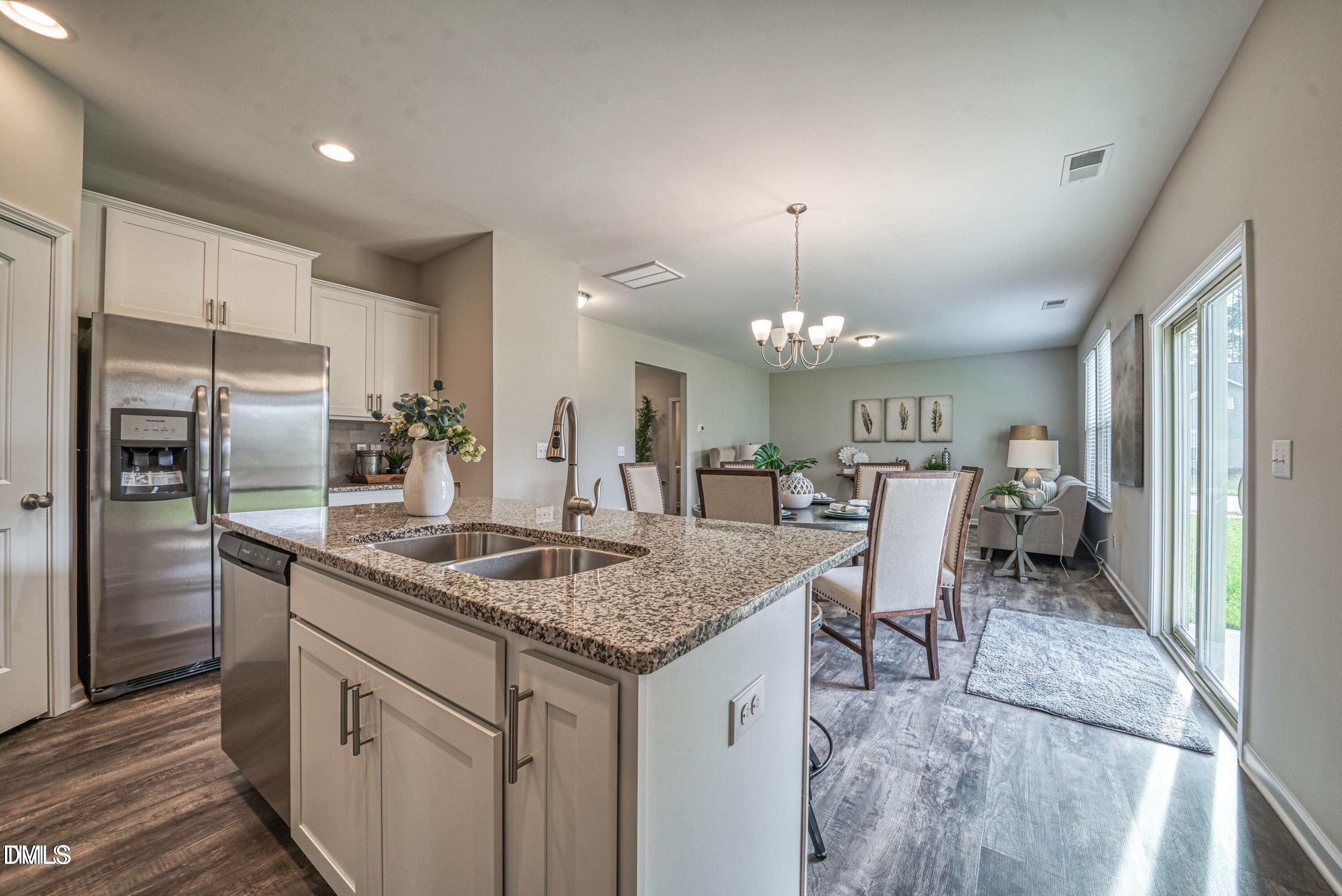 2304 Broad Street Durham, NC 27704 - Photo 4 of 39 a kitchen with stainless steel appliances granite countertop a sink stove and refrigerator