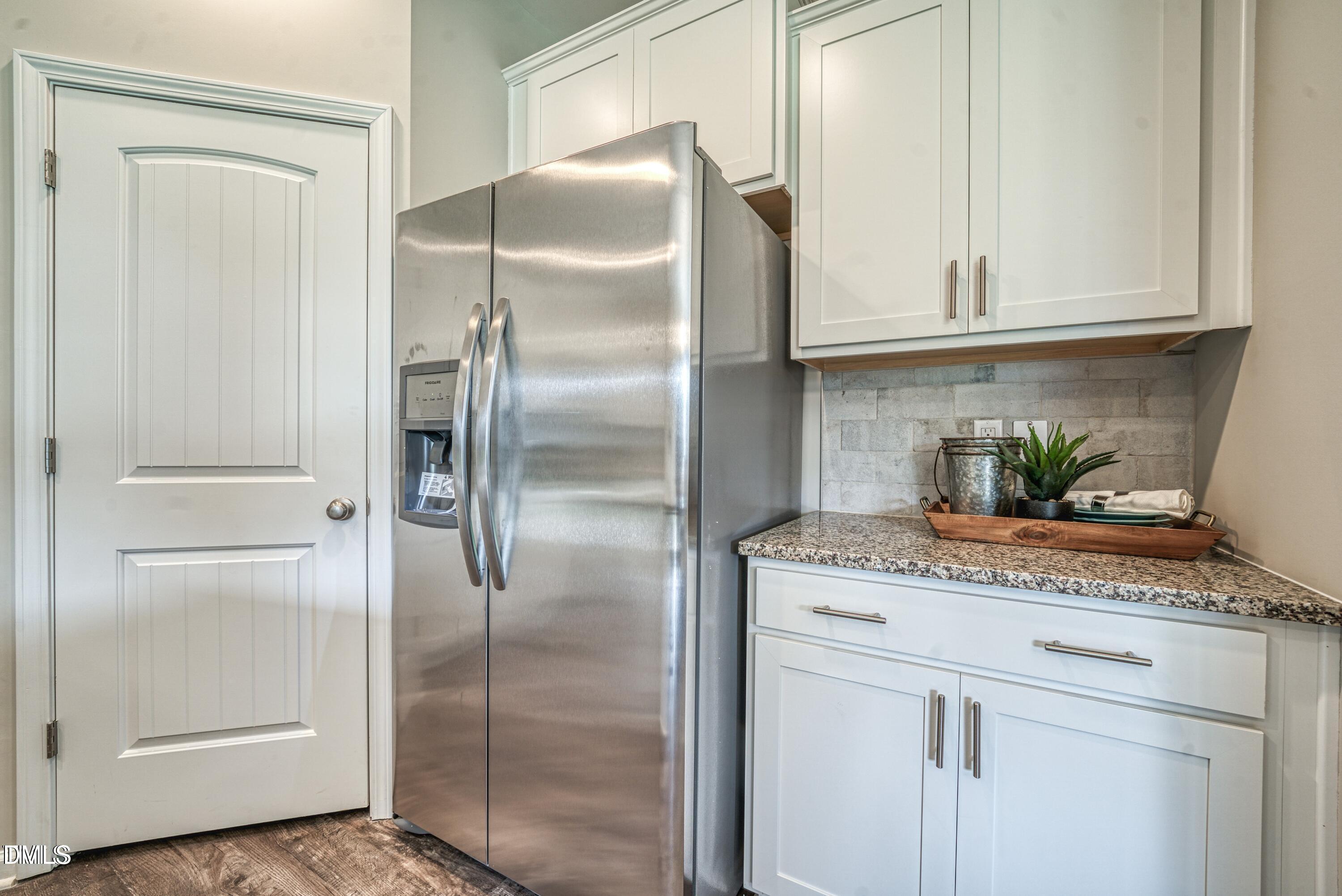 2304 Broad Street Durham, NC 27704 - Photo 6 of 39 a kitchen with granite countertop a refrigerator and cabinets