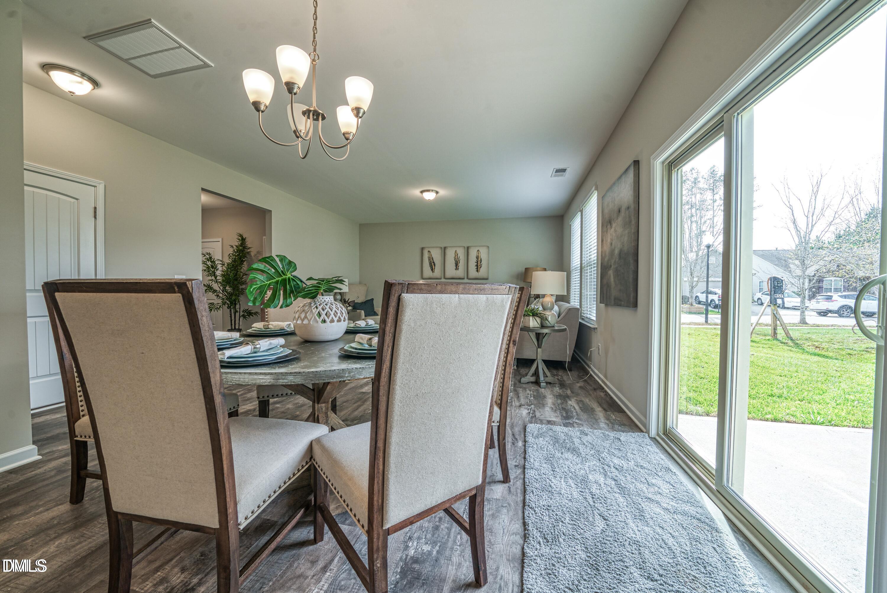 2304 Broad Street Durham, NC 27704 - Photo 8 of 39 a view of a dining room with furniture wooden floor and chandelier