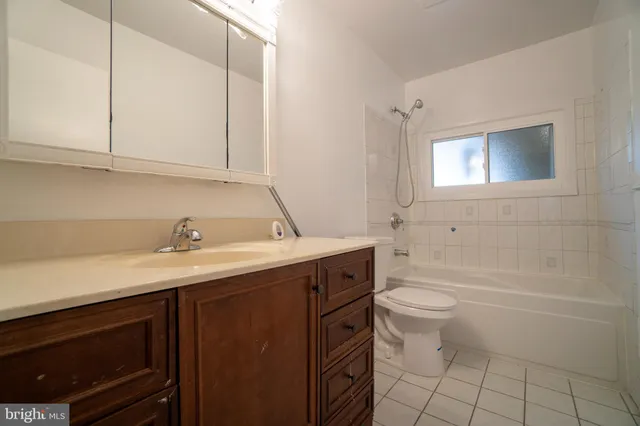 a bathroom with a sink a toilet and bathtub