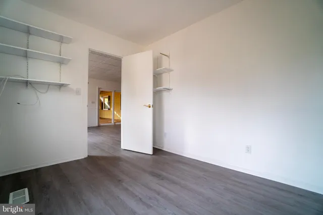 a view of a room with wooden floor and a window
