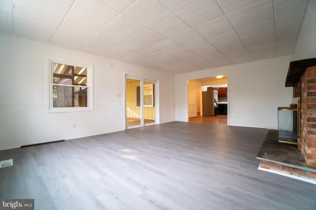 a view of a livingroom with wooden floor and a flat screen tv