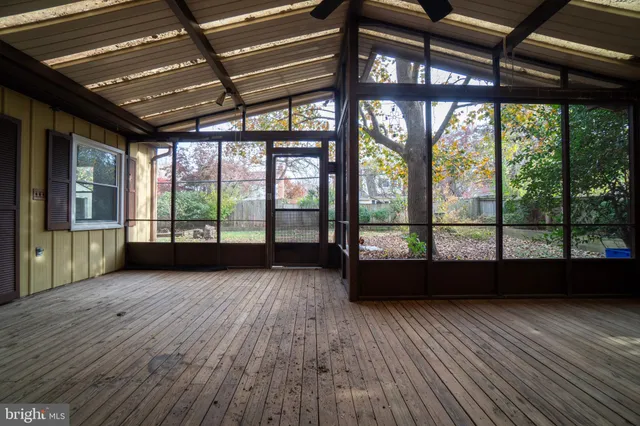 a view of room with wooden floor and door