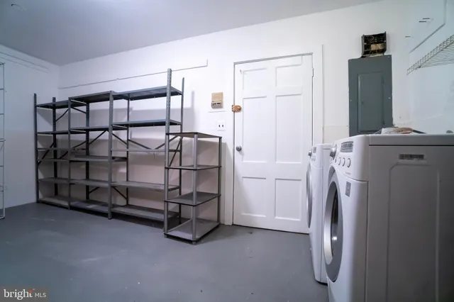 a bedroom with a bed and a washing machine