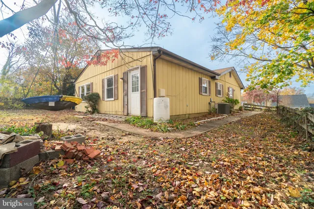a view of a room with wooden floor and a fireplace