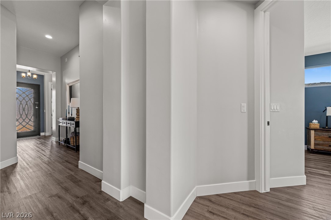1436 Manassas Ridge Mesquite, NV 89027 - Photo 13 of 77 Rich hardwood-style flooring extends from the front entry throughout this flowing interior space.