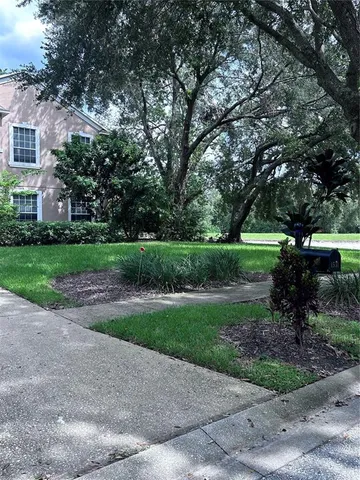 a view of a park with a house in the background