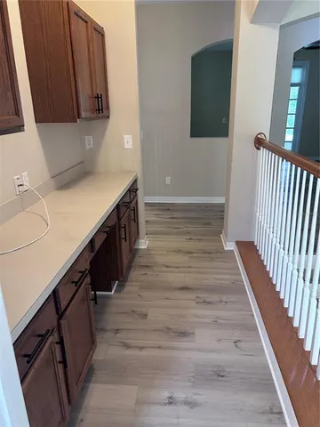 a view of a hallway with wooden floor and entryway