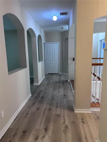 an empty room with wooden floor and closet