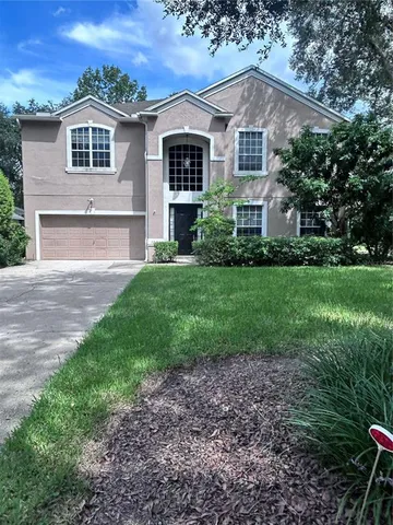 a front view of house with yard and green space