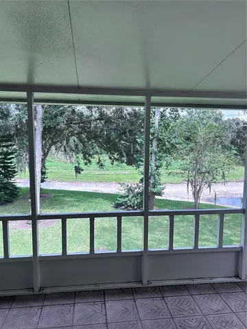 a view of a porch with wooden floor and windows