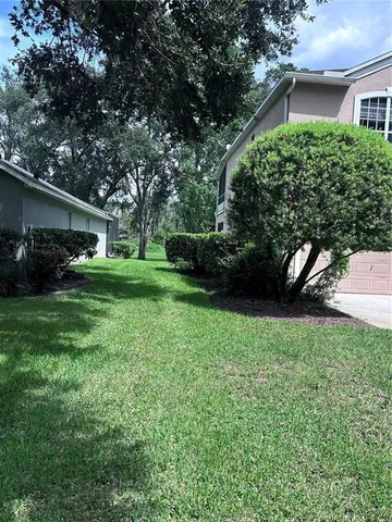 a view of a house with a backyard