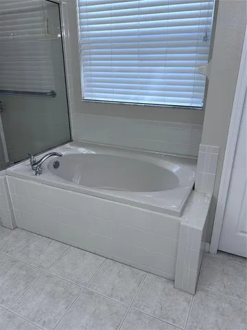 a white toilet sitting next to a shower