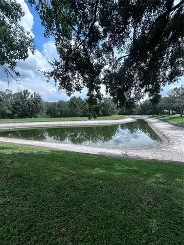 a view of outdoor space with swimming pool and green space