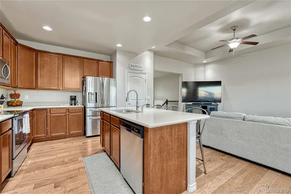 a kitchen with a stove sink cabinets and refrigerator