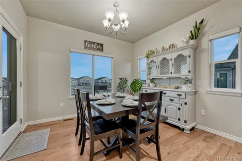 a view of a dining room with furniture and chandelier