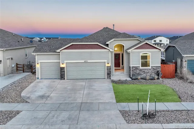 a view of a livingroom with wooden floor and staircase