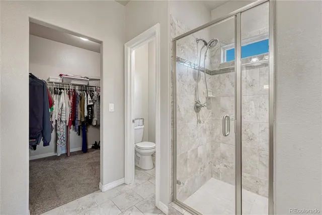 a living room with furniture a flat screen tv and a large window