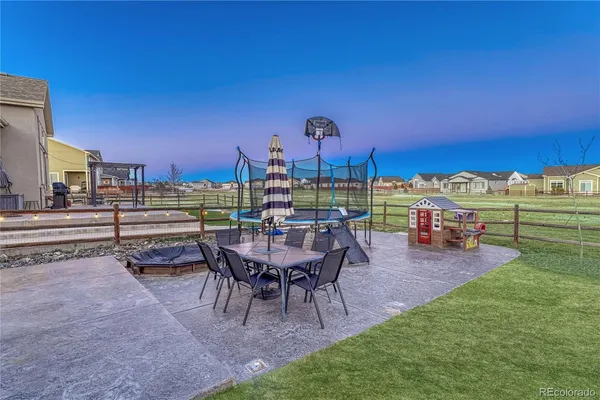 a view of a chairs and table in patio with a yard