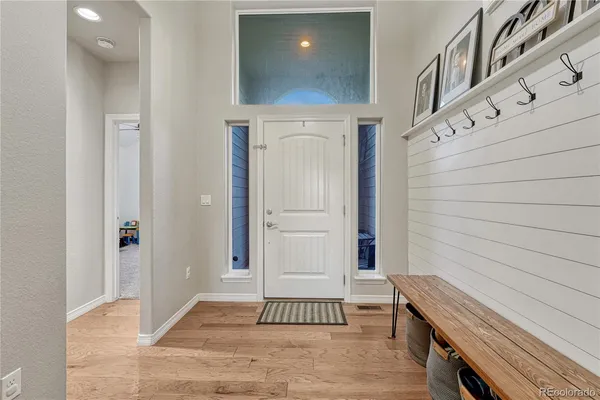 a view of a livingroom with wooden floor and staircase