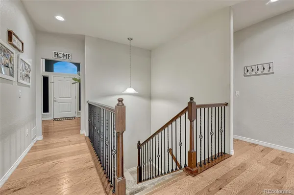 a view of a hallway with wooden floor and entryway