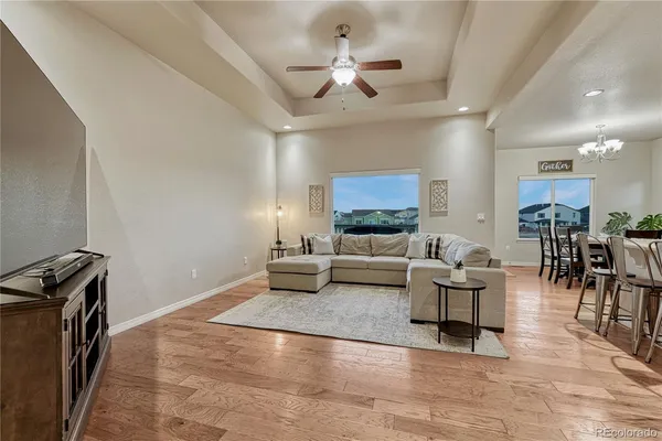 a living room with furniture and view of kitchen