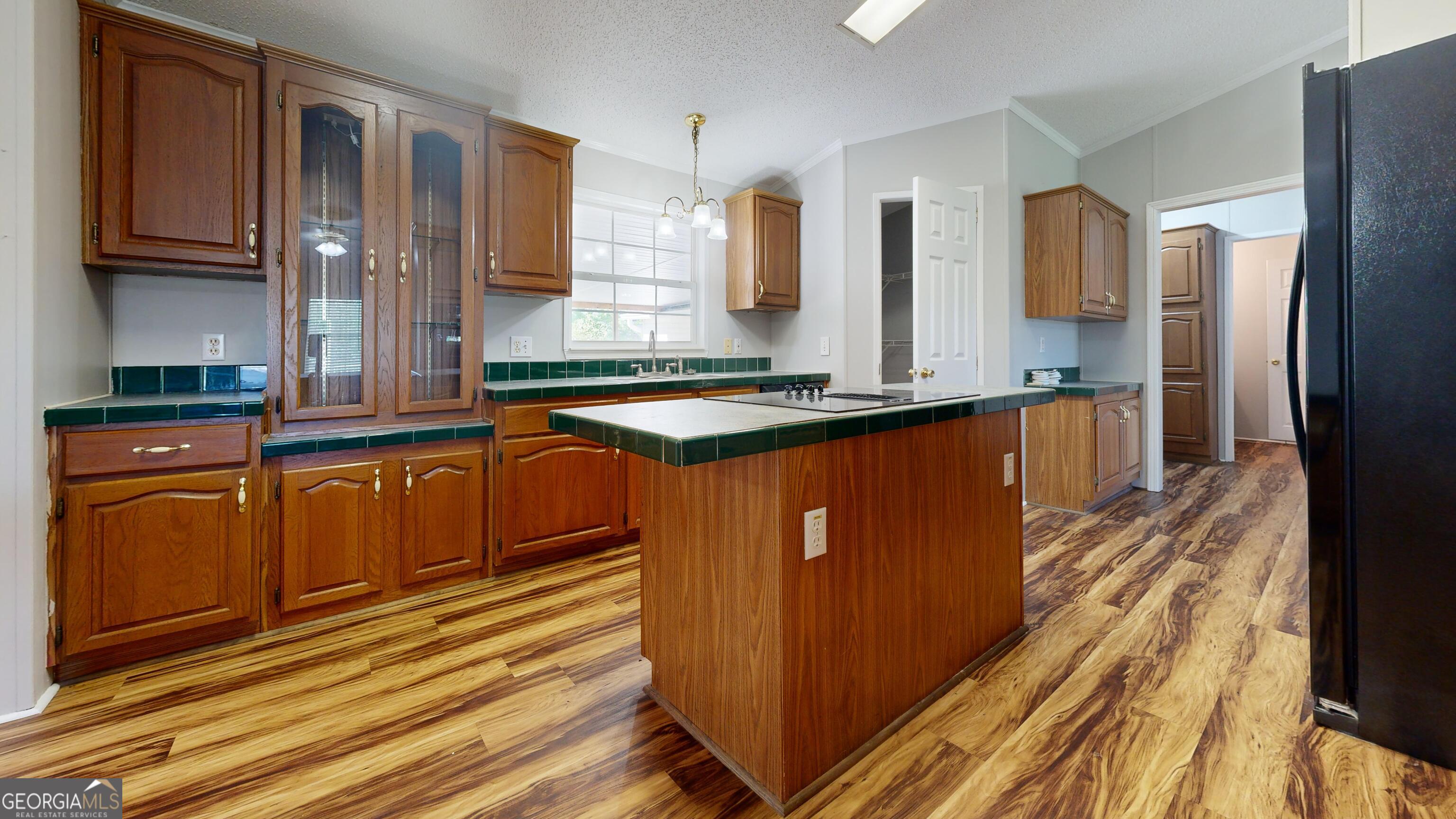 6498 Central Avenue Waycross, GA 31503 - Photo 10 of 20 a kitchen with stainless steel appliances granite countertop a refrigerator a sink dishwasher and wooden cabinets with wooden floor