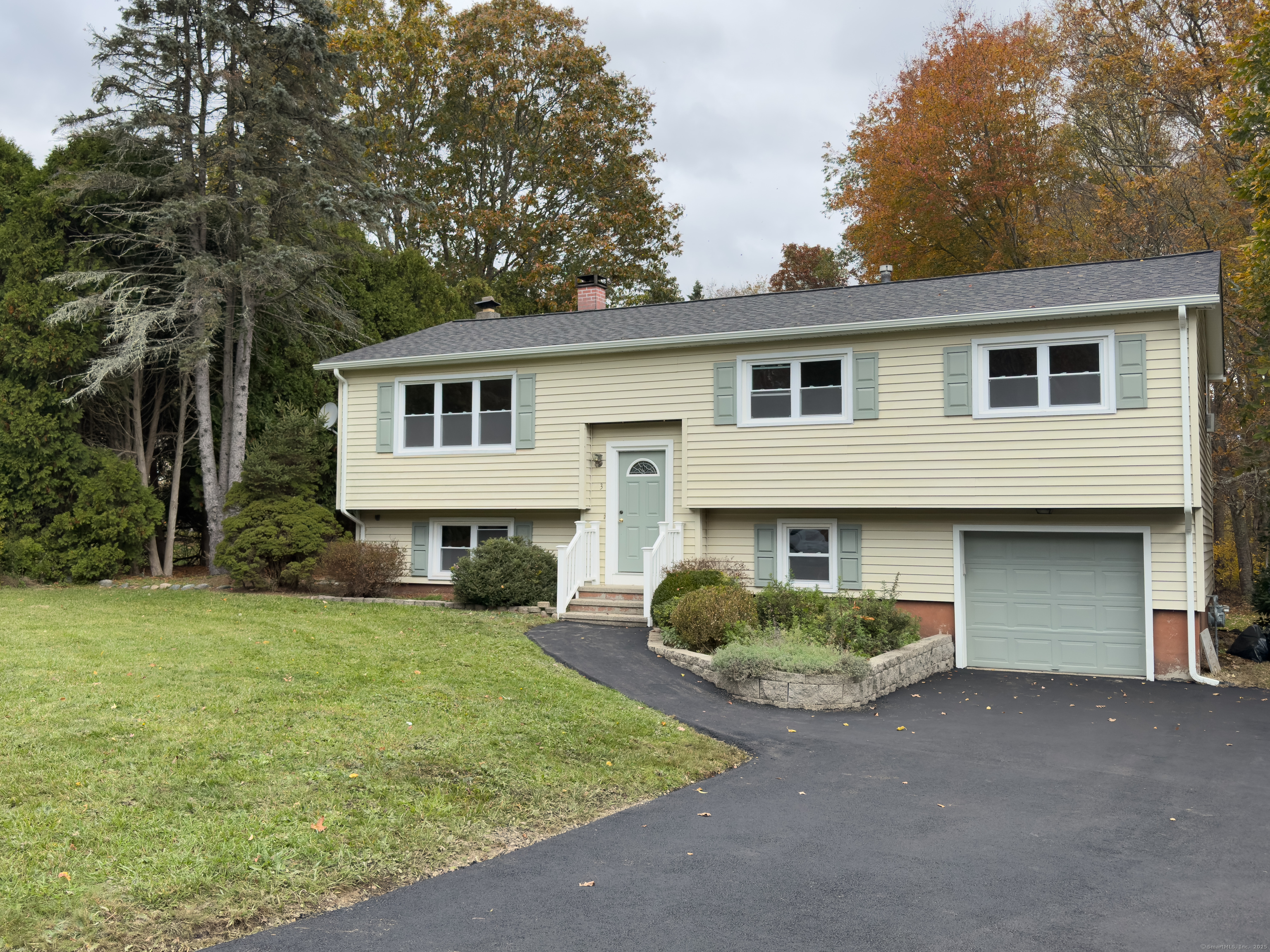 3 Fairview Drive Stonington, CT 06379 - Photo 1 of 20 a view of a yard in front of a house with plants and large tree