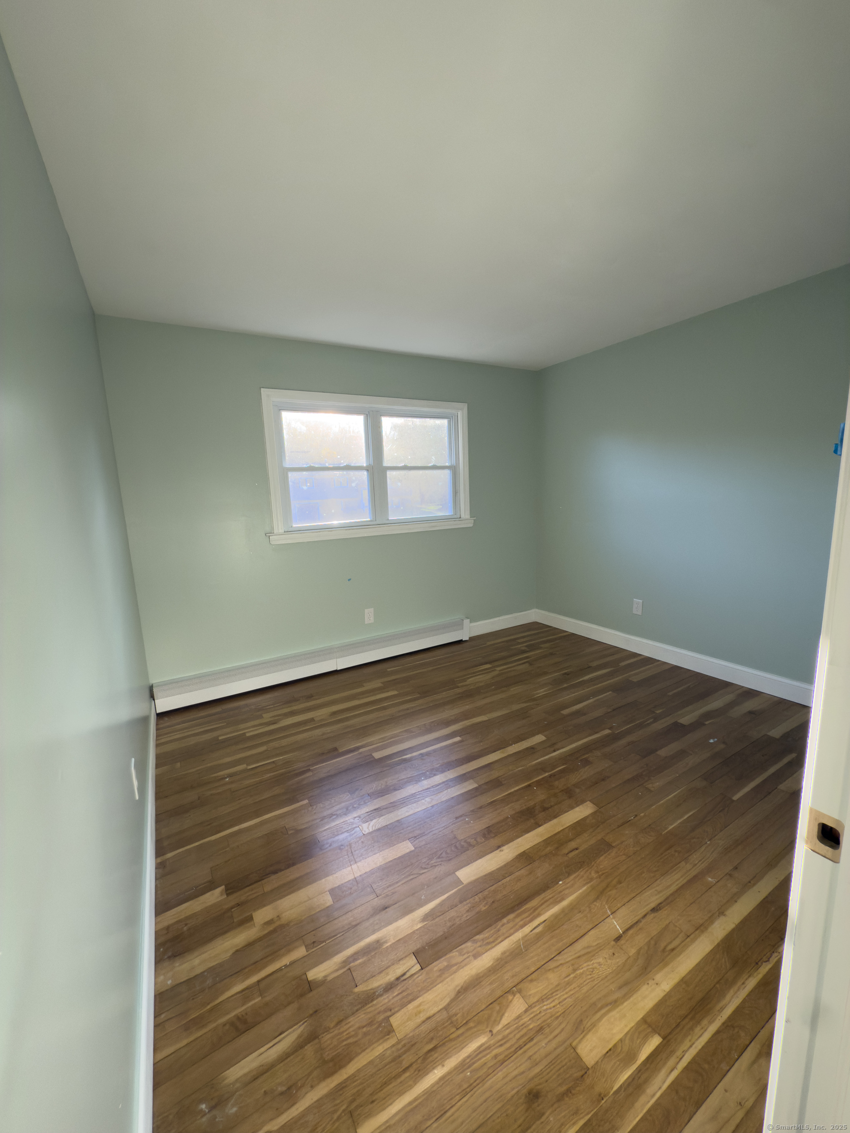 3 Fairview Drive Stonington, CT 06379 - Photo 11 of 20 an empty room with wooden floor and windows