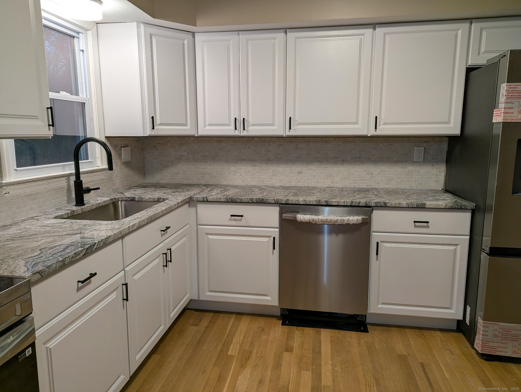 3 Fairview Drive Stonington, CT 06379 - Photo 2 of 20 a kitchen with stainless steel appliances granite countertop a stove a sink and white cabinets