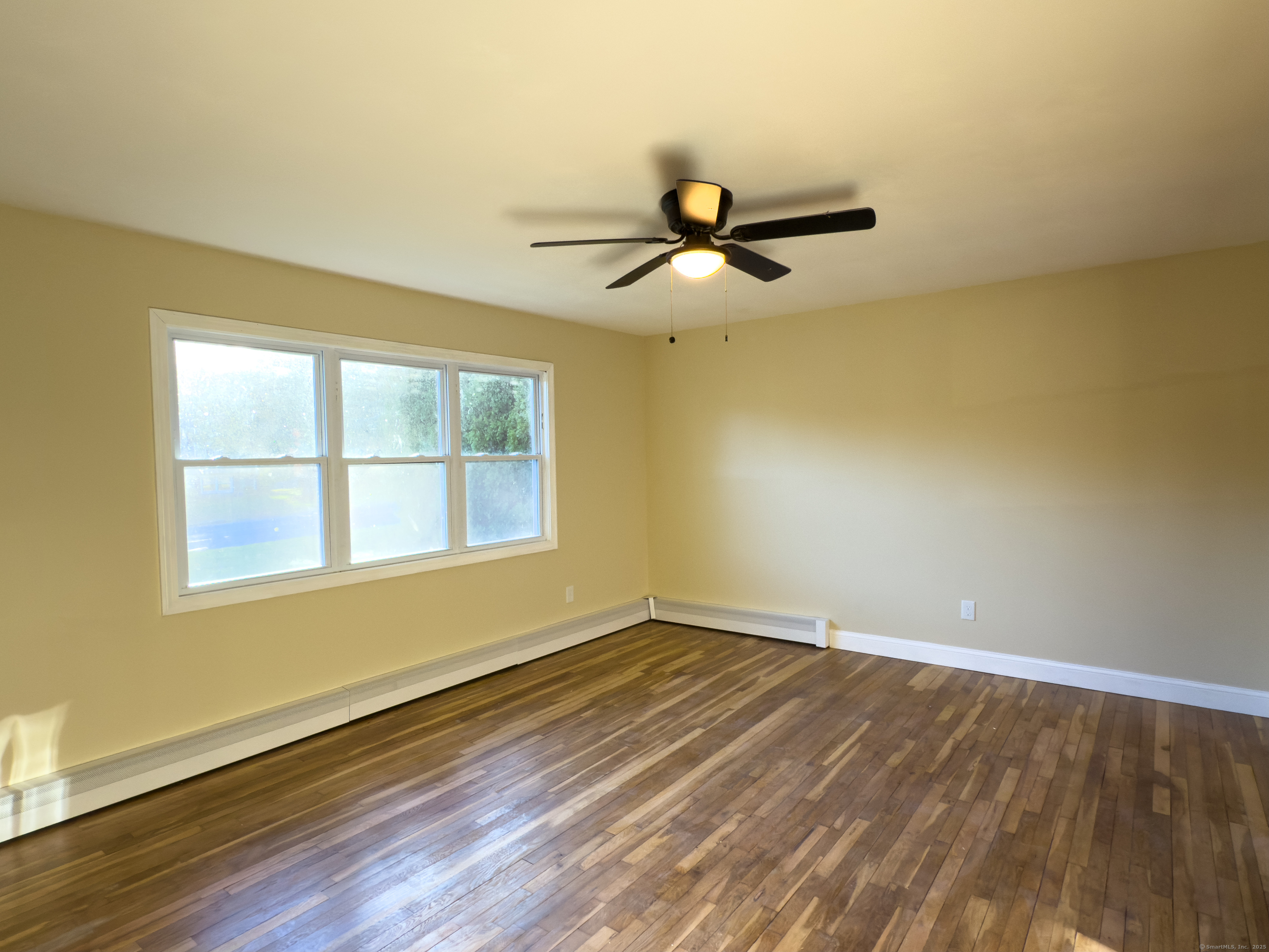 3 Fairview Drive Stonington, CT 06379 - Photo 4 of 20 a view of empty room with wooden floor and fan