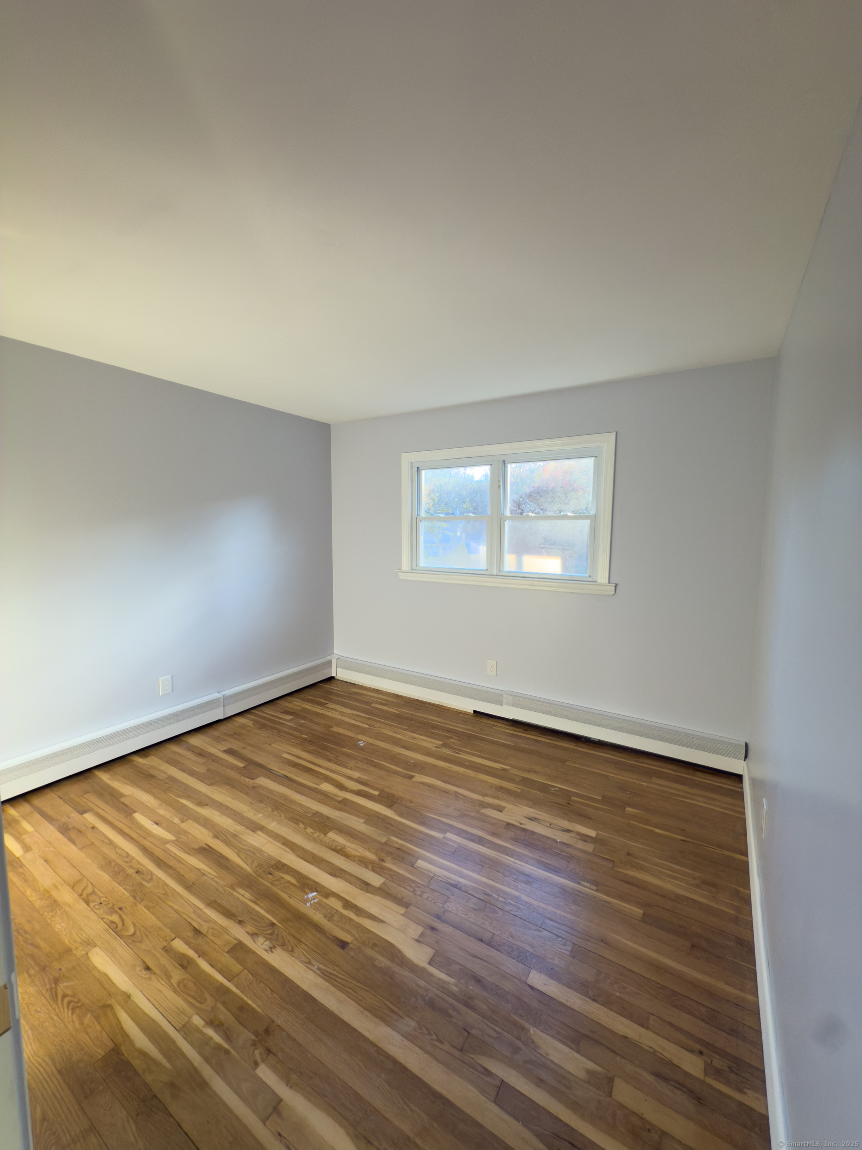 3 Fairview Drive Stonington, CT 06379 - Photo 9 of 20 an empty room with wooden floor and windows