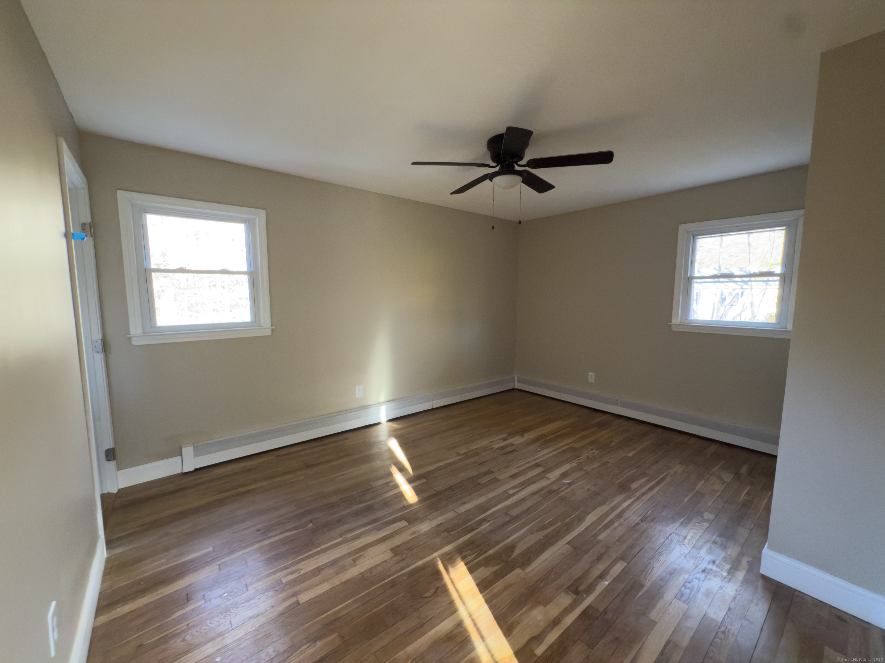 3 Fairview Drive Stonington, CT 06379 - Photo 10 of 20 a view of an empty room with wooden floor and a window