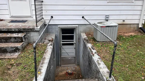 a backyard of a house with table and chairs