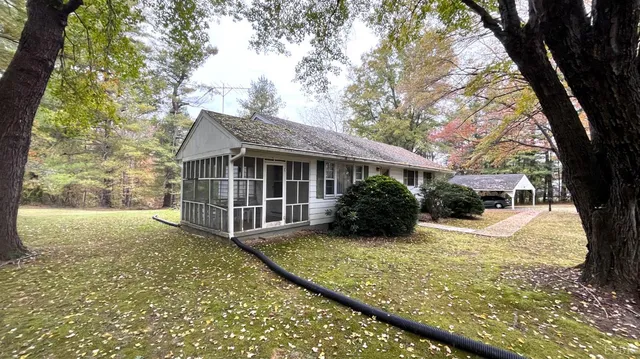 a view of a house with a yard covered in snow