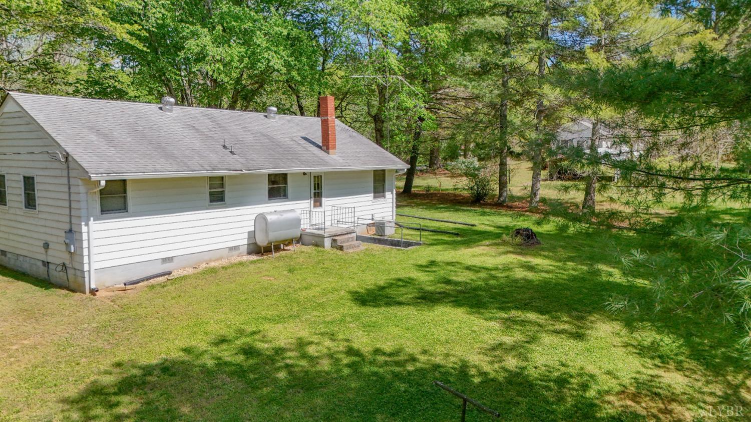 1091 Acorn Road Nathalie, VA 24577 - Photo 30 of 42 a backyard of a house with table and chairs