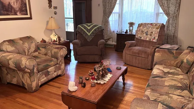 a living room with furniture rug and wooden floor