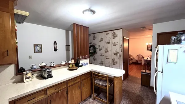 a kitchen with stainless steel appliances a sink a stove a refrigerator and cabinets