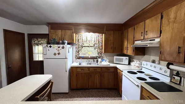 a kitchen with a sink a stove and cabinets