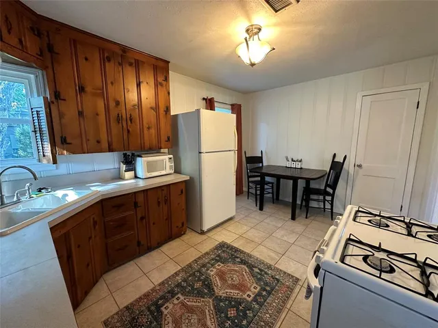 a kitchen with a stove a sink and a refrigerator