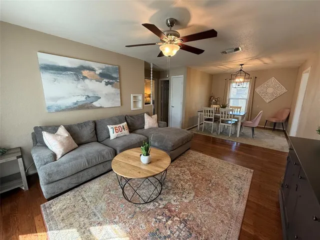 a living room with furniture and wooden floor