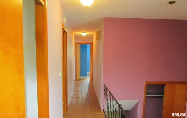 a view of a hallway with stairs