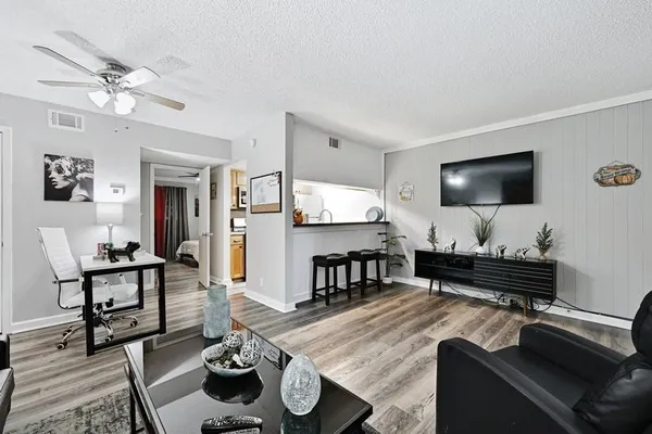 a living room with furniture and a flat screen tv